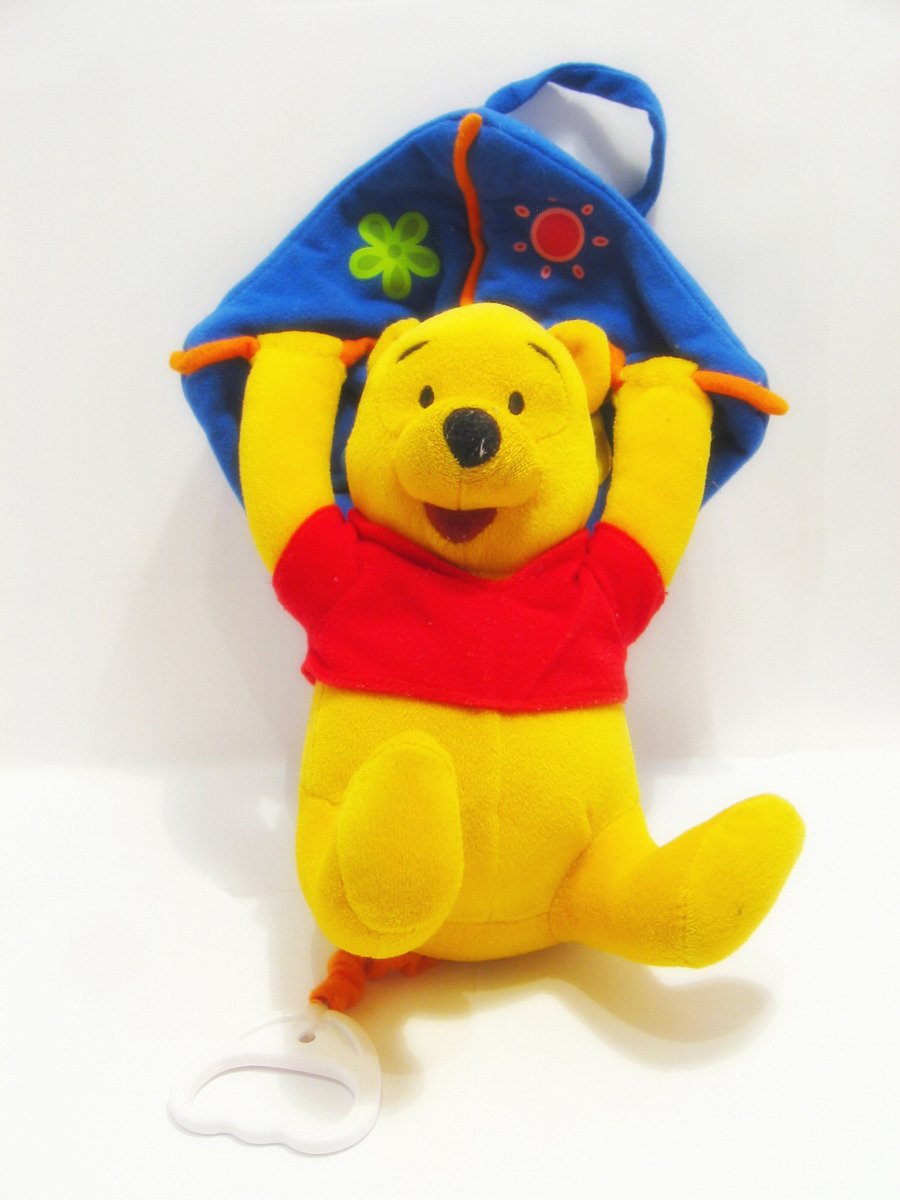 a stuffed winnie the pooh bear has its hands up