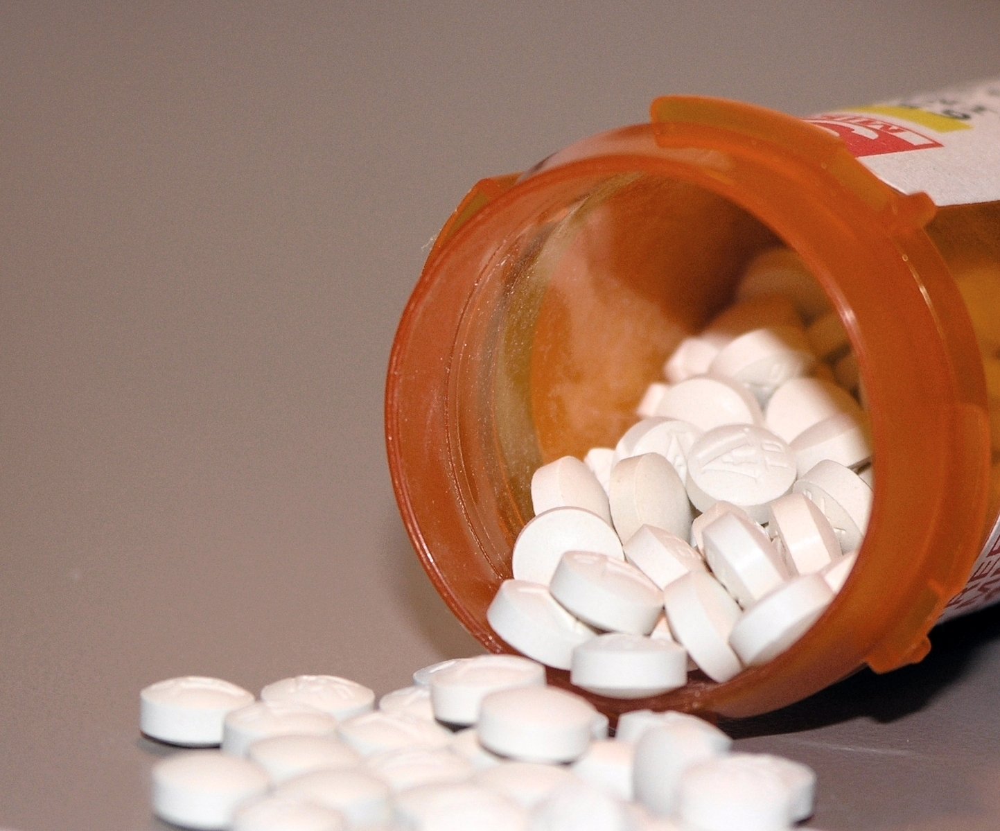 pills coming out of an open prescription bottle