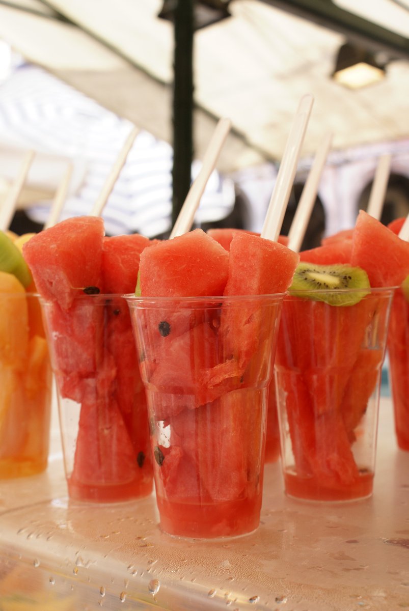 several cups filled with slices of fruit sitting on a table