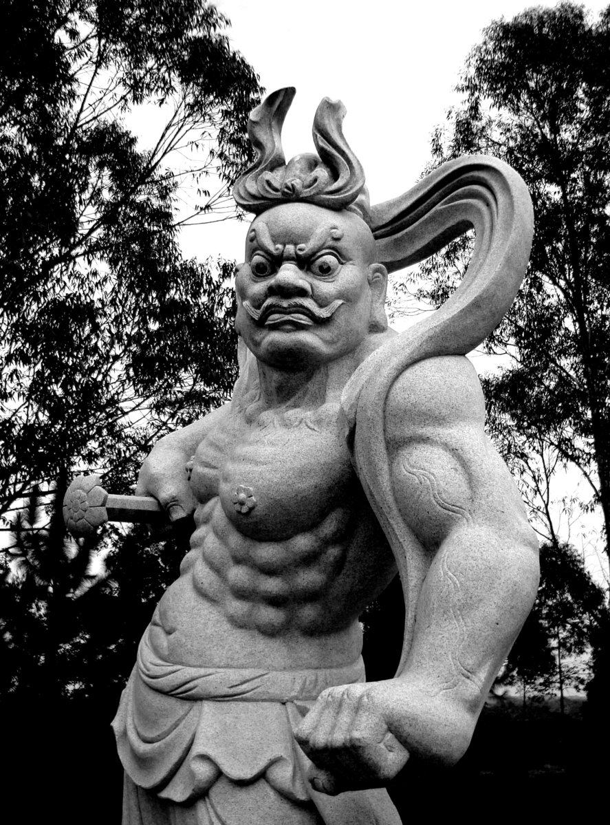 a statue with the devil's horns is shown against a white sky