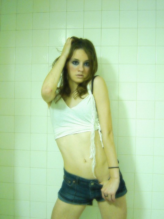 a very attractive young lady posing in the bathroom