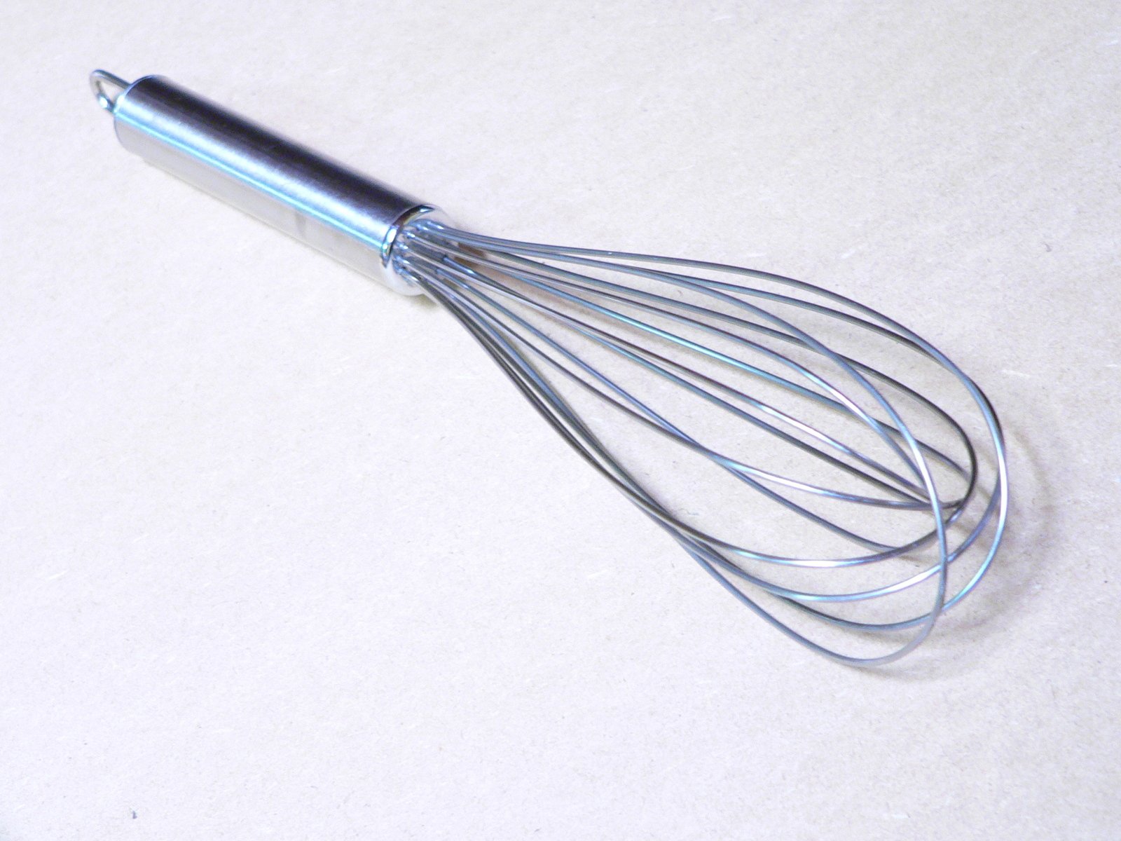 a small metal whisk on top of a table