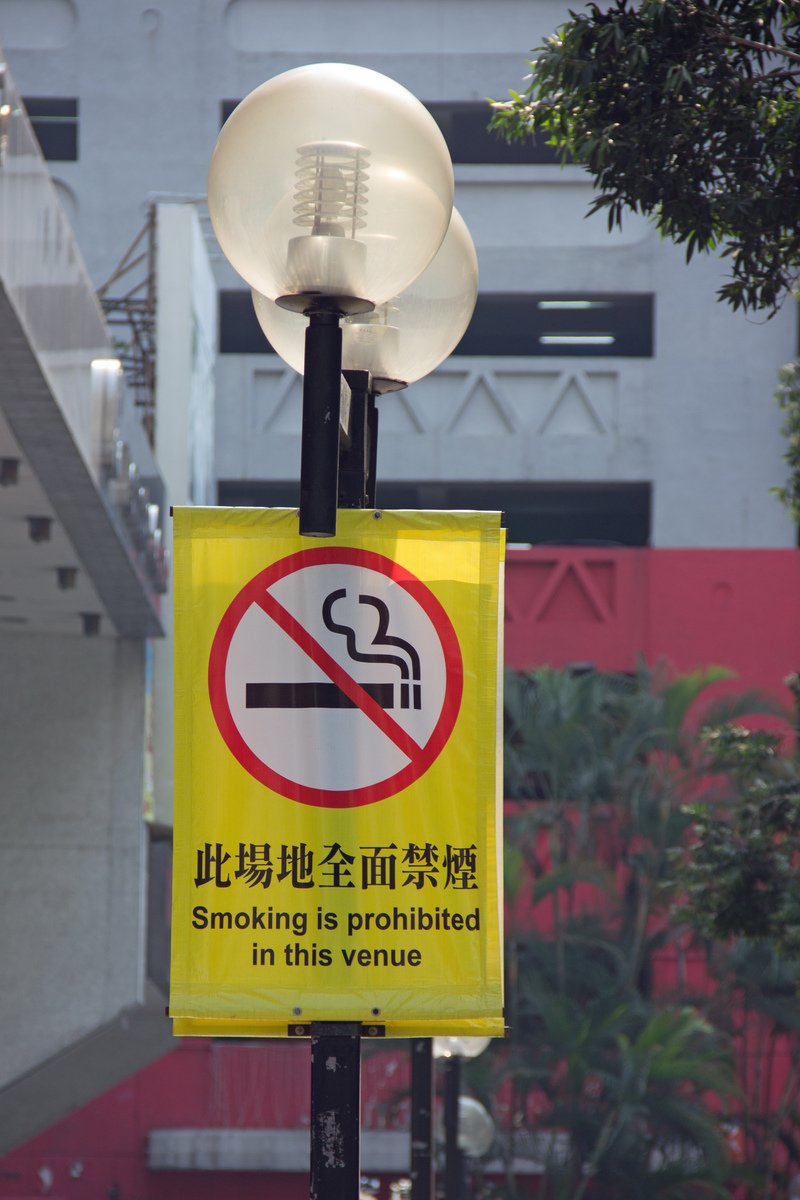 a streetlight with a no smoking sign on it