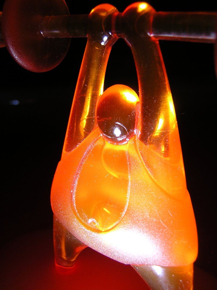 a close up of the top part of a orange glass