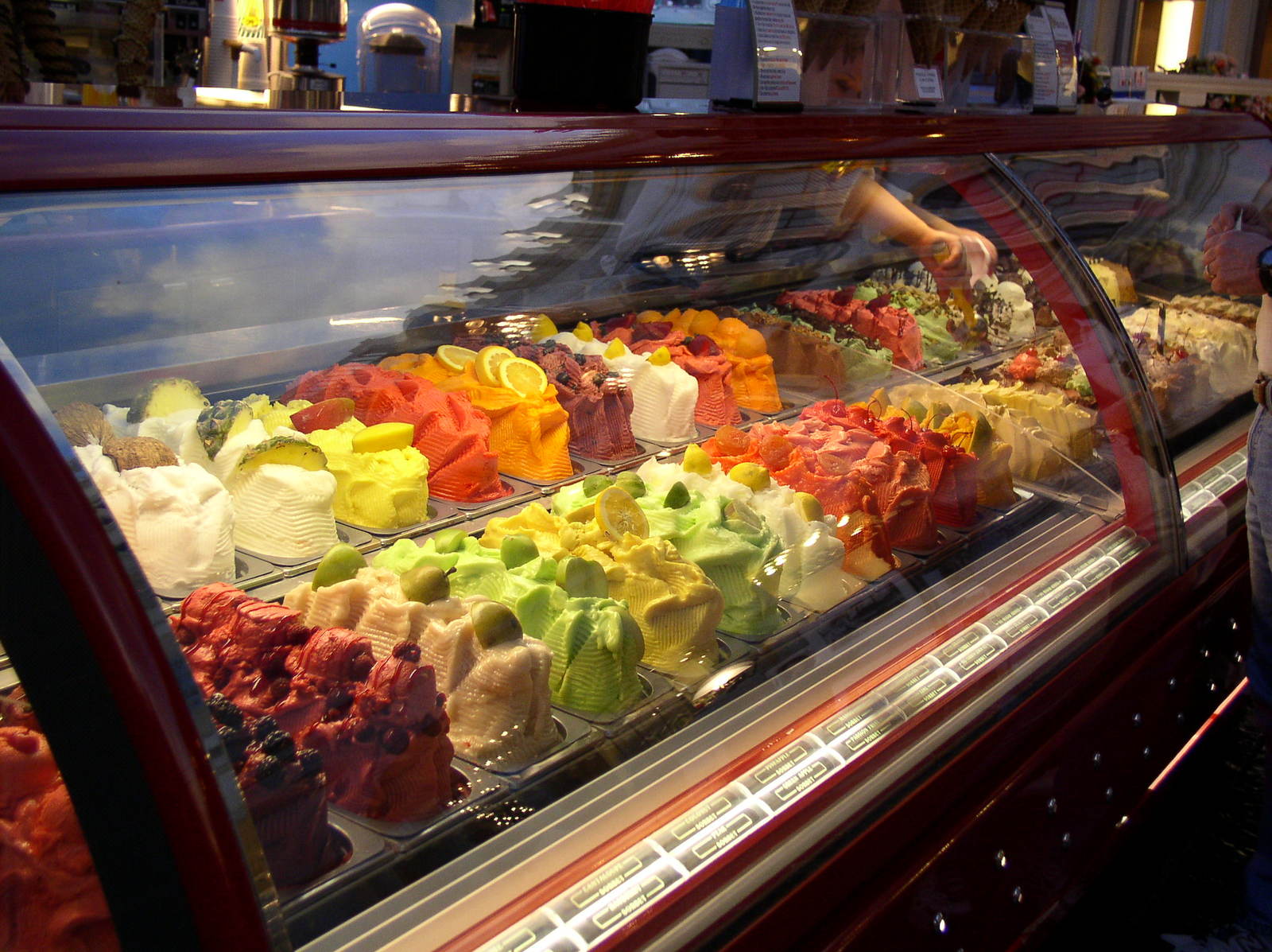 the display cases have different kinds of sweets