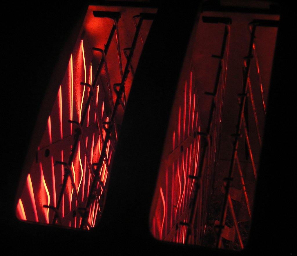 there are red light emitting through windows on a bridge