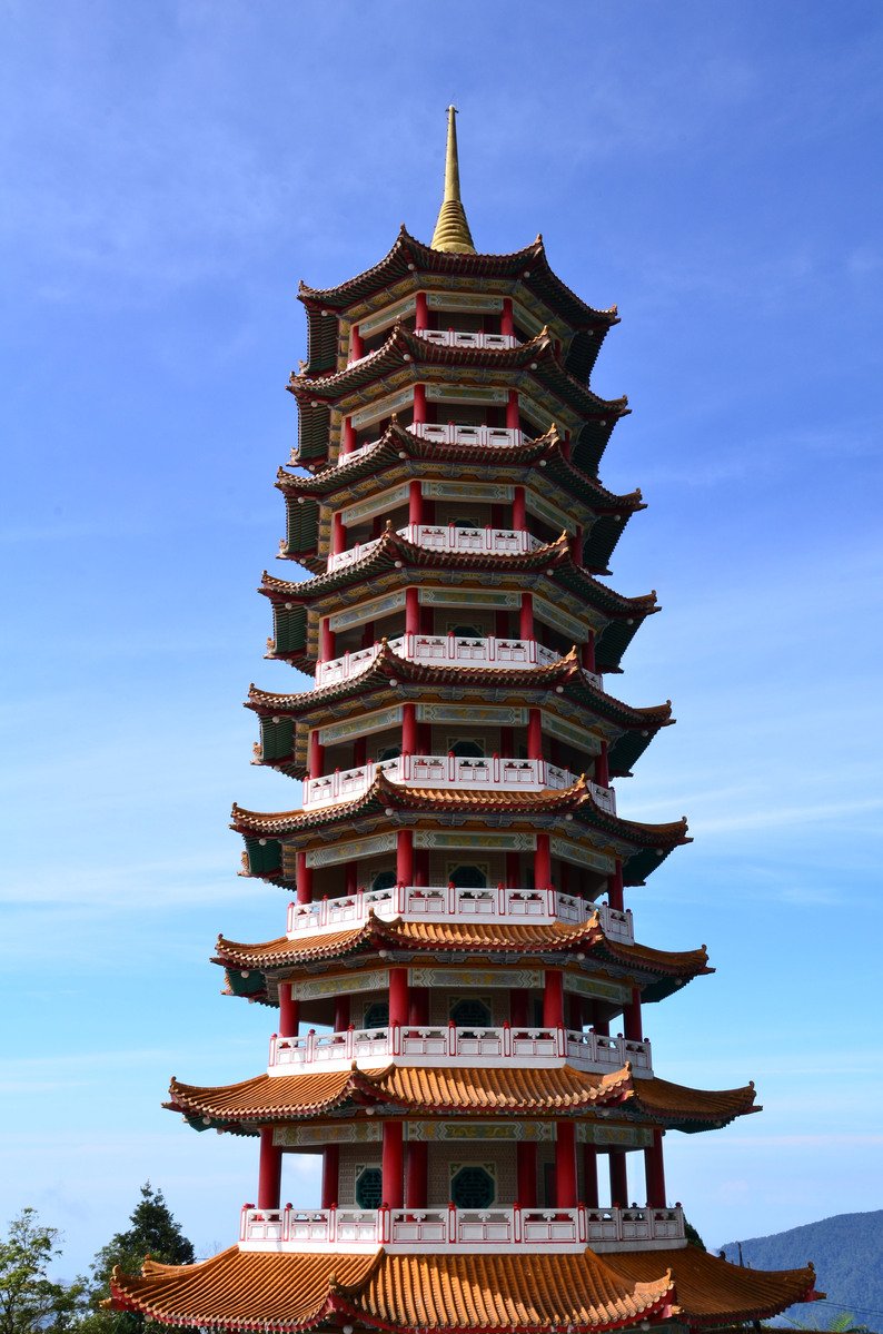 a tall tower that has red trim and many floors