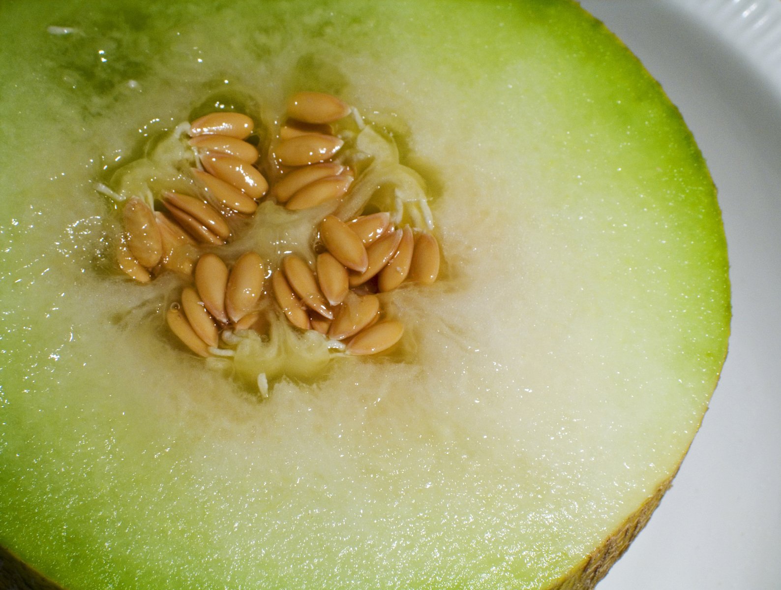 a piece of fruit is shown with peanuts inside of it