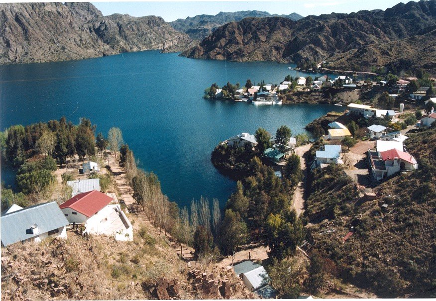 an aerial view of a town by a lake