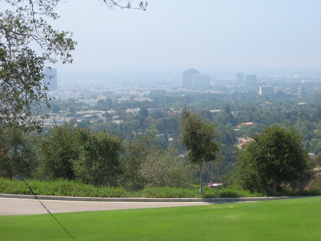 view of a city, a park and a large field