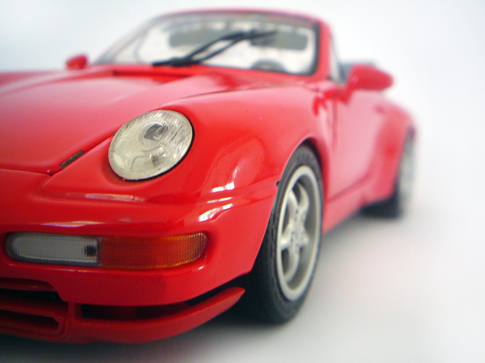 close up of the front of a red toy porsche