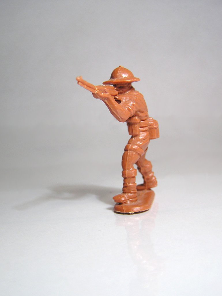 a figurine of a man in a fireman uniform pointing soing to his left