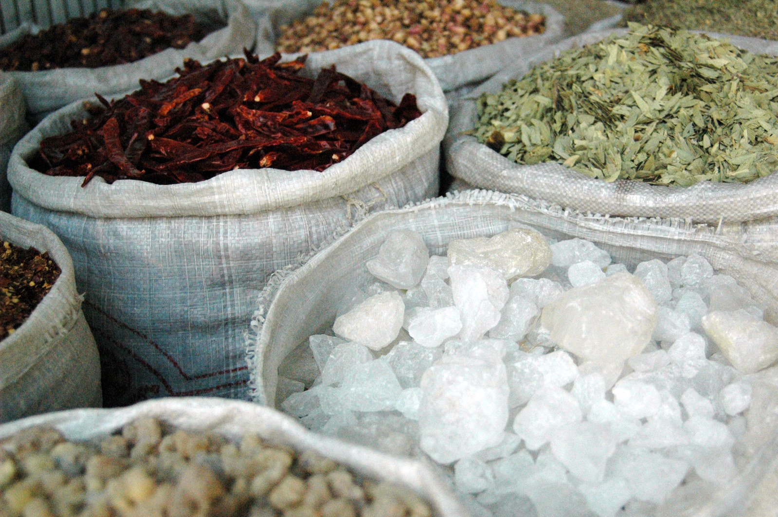 several bags filled with different types of spices and herbs