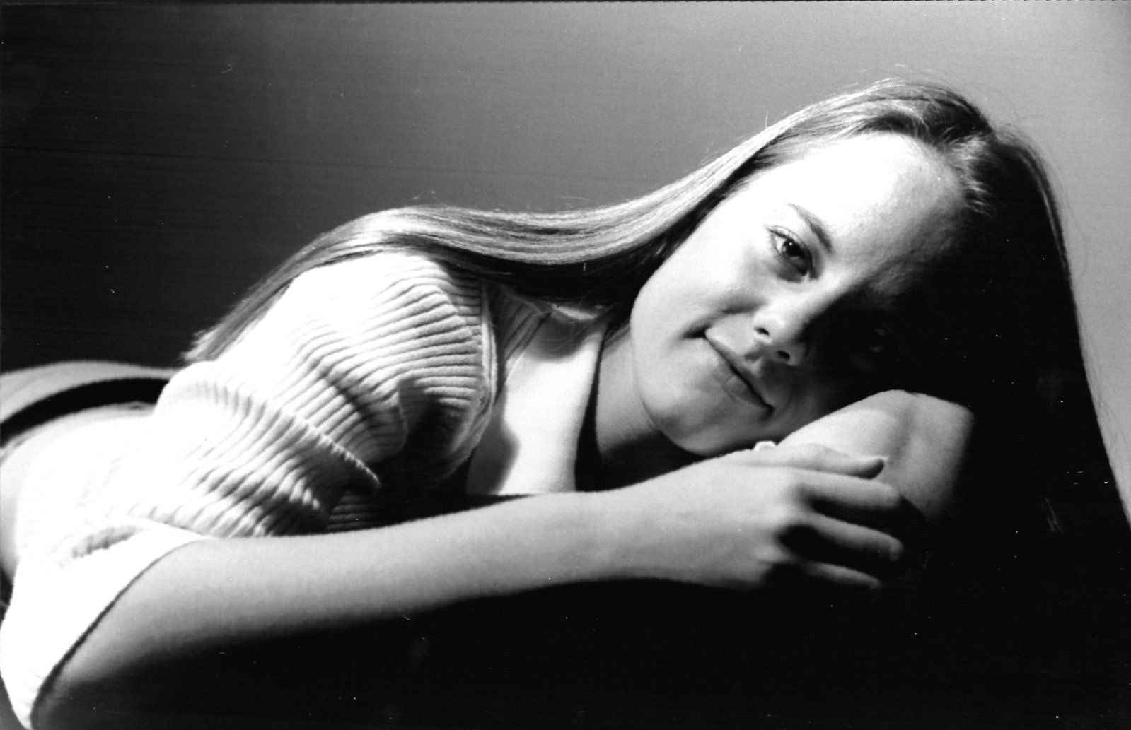 a black and white po of a young woman with her hand on the shoulders