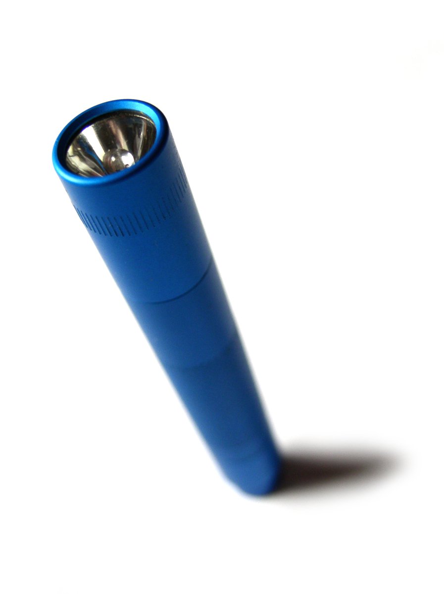 blue lighter on white surface with one light turned on