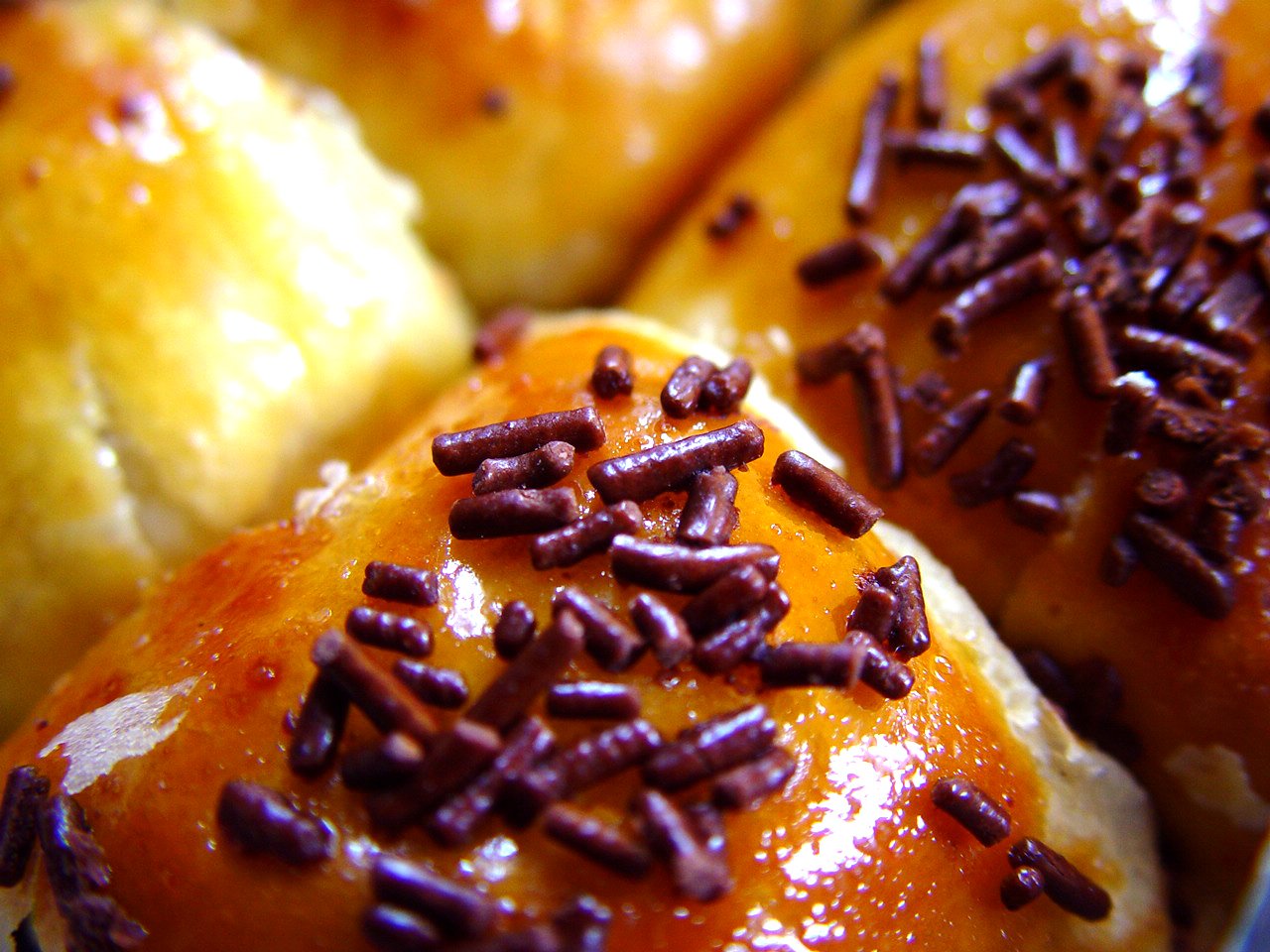 an assortment of pastries, including chocolate and donuts