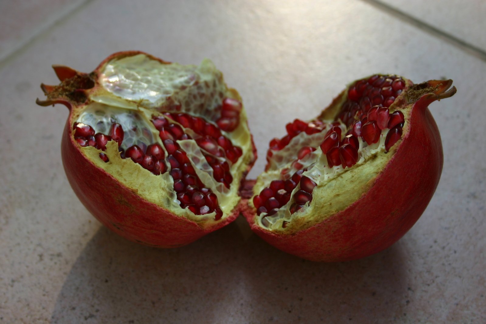 an open pomegranate sits on a counter top