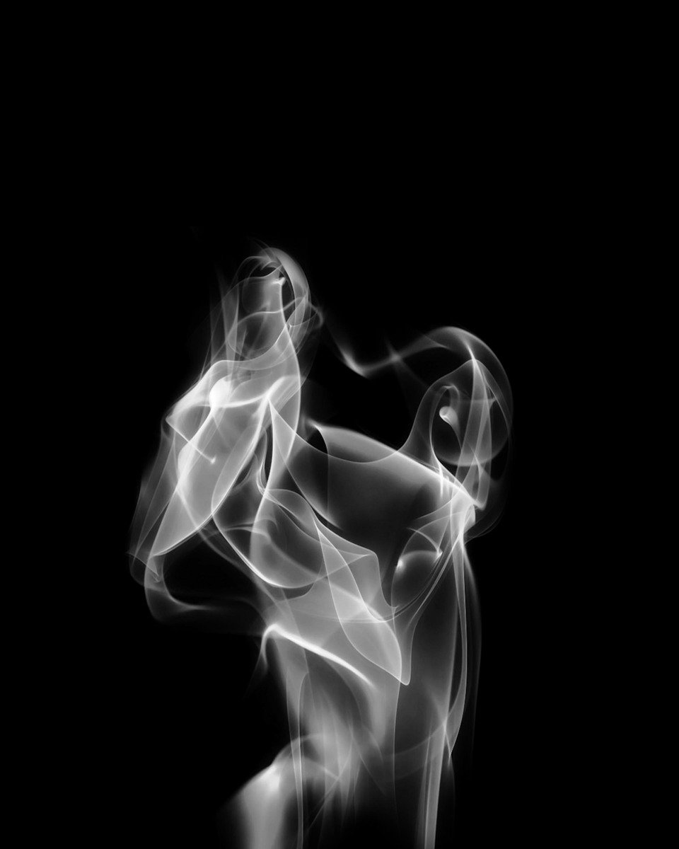smoke coming from a black background like a woman