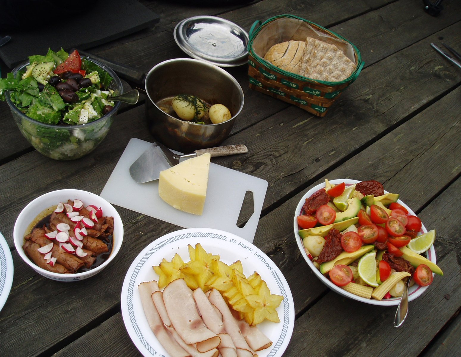 various food items being prepared on picnic table