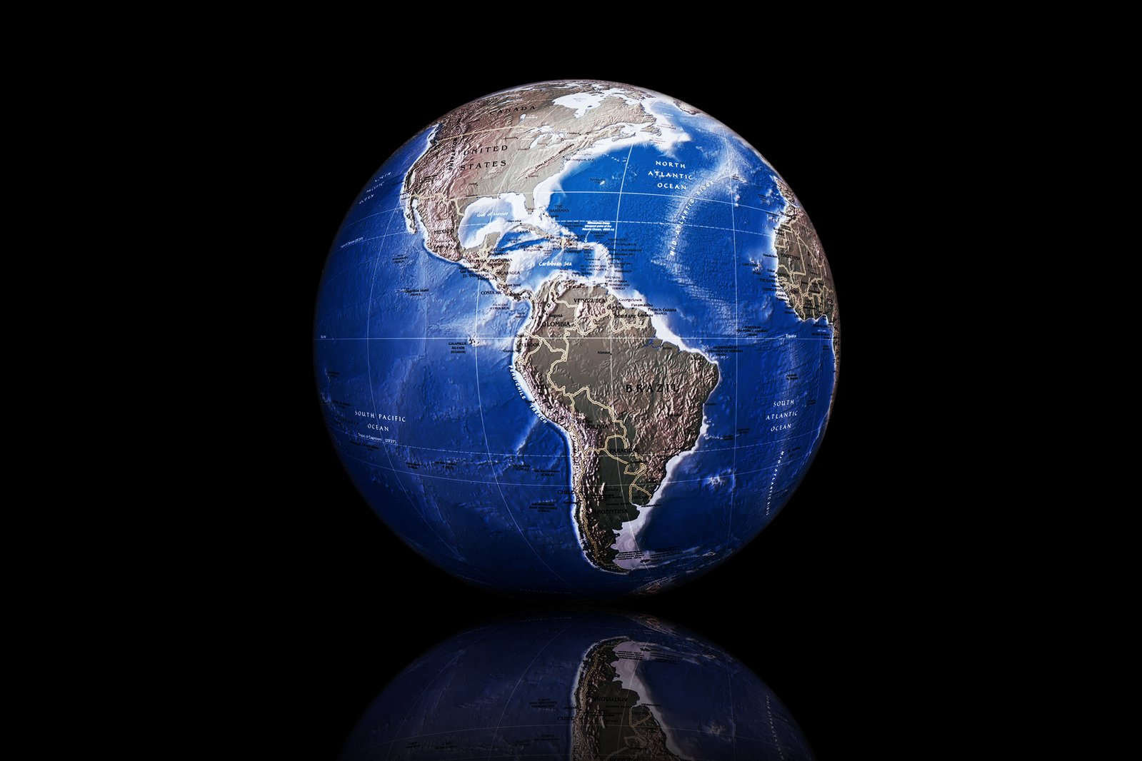 a blue globe on black with reflection on the bottom