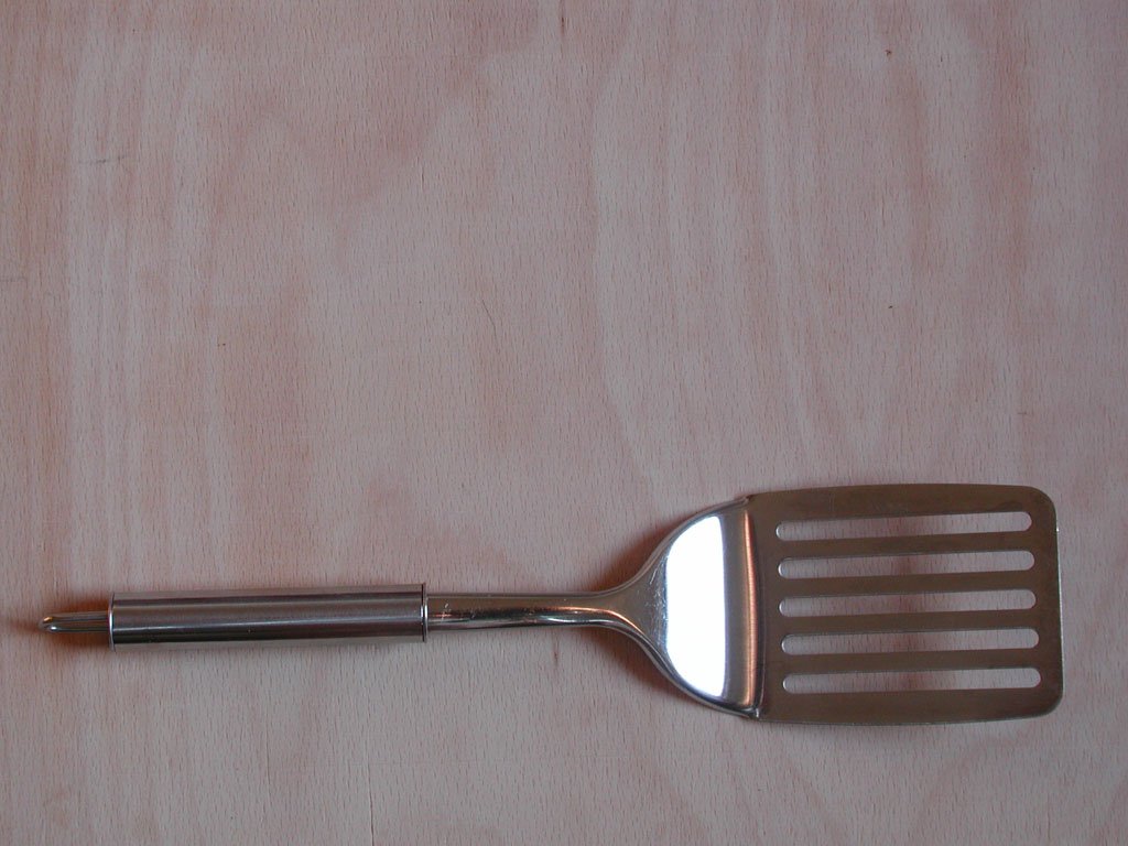 a small grilling spatula sitting on a counter