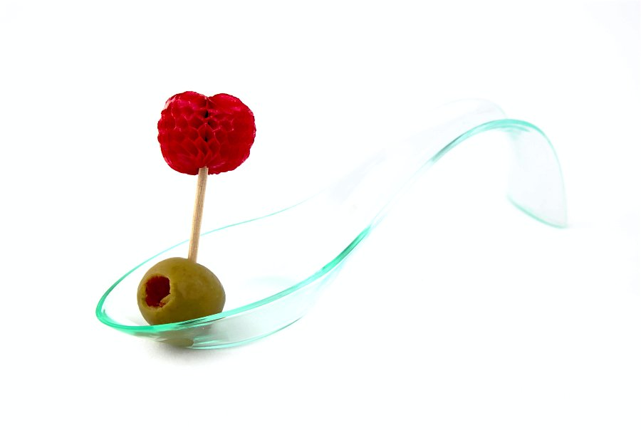 a pickled berry with green olives in a small bowl