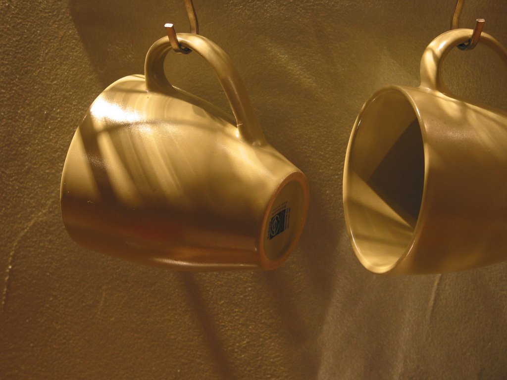 two cups with handles that are very similar