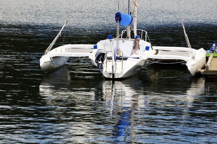 an image of boats floating on water near shore