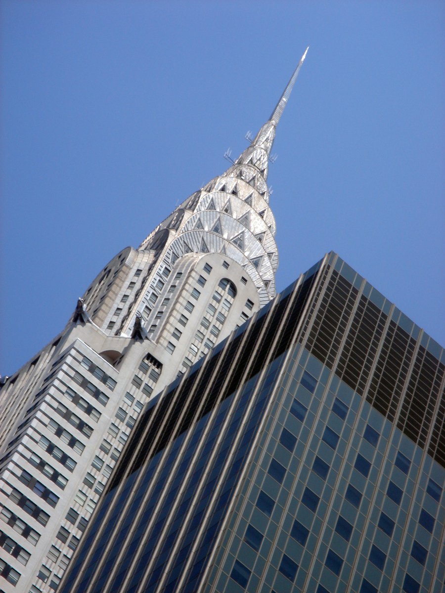 the spire of a large building and other tall buildings