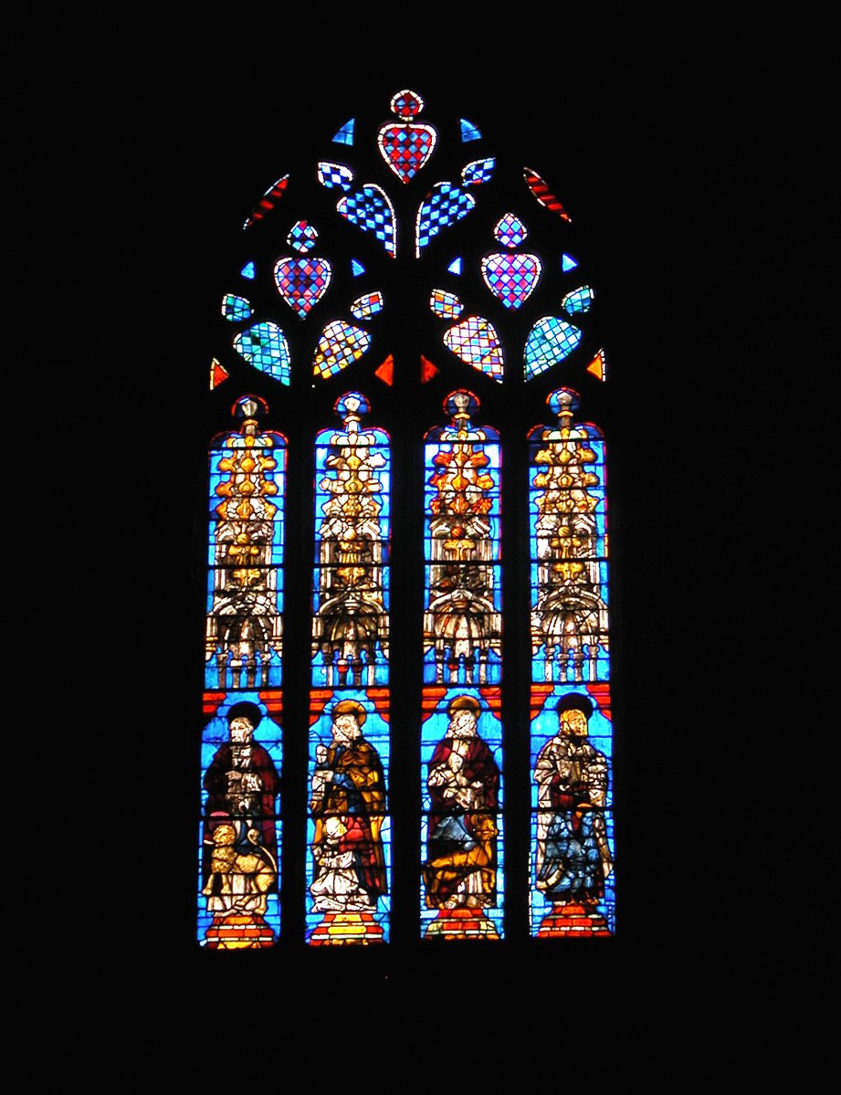 the large stained glass window is in front of the wall