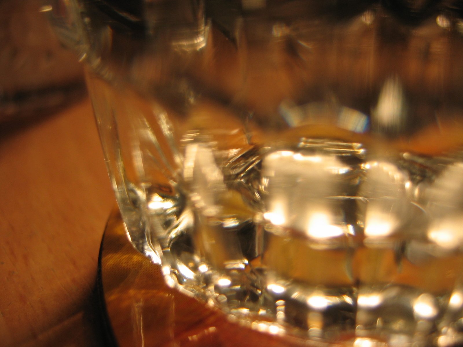 glass filled with liquid with a wooden table