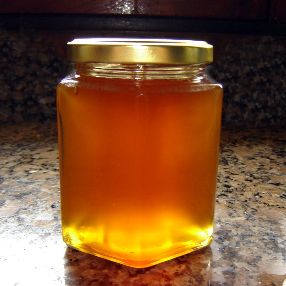 a jar of honey sitting on a counter