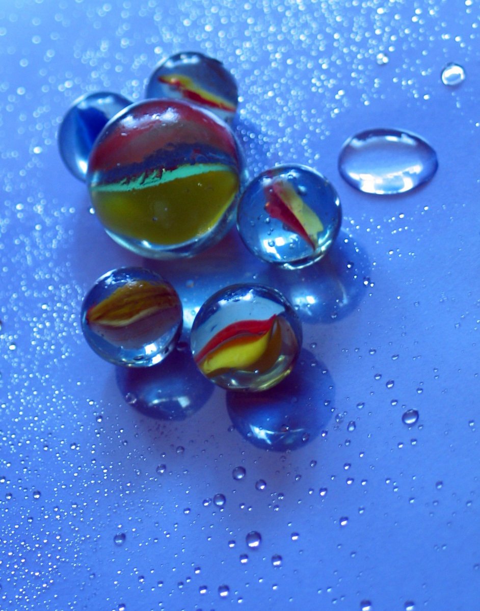 an array of bubble shapes laying on blue liquid