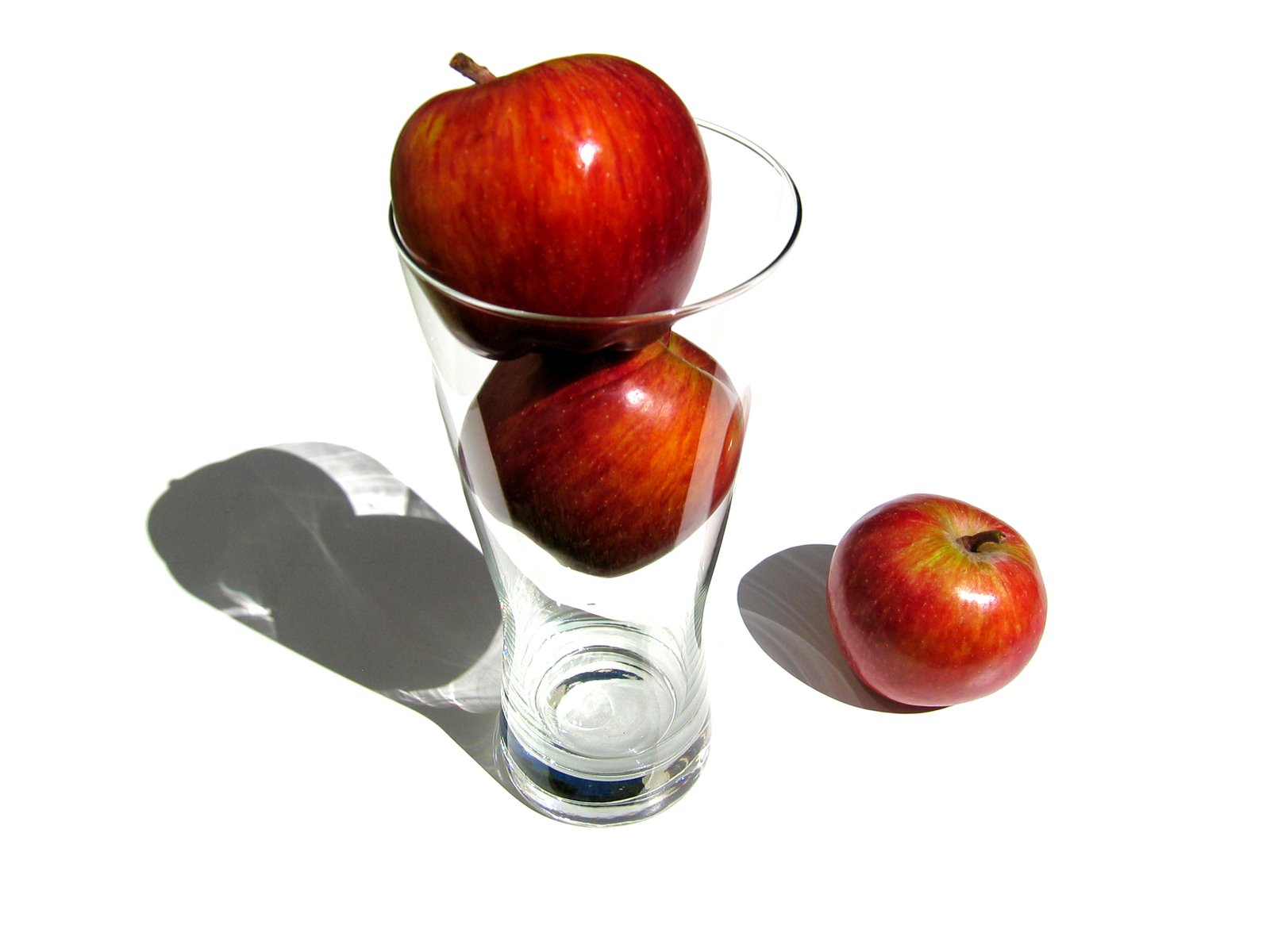 there is an apple in a glass vase
