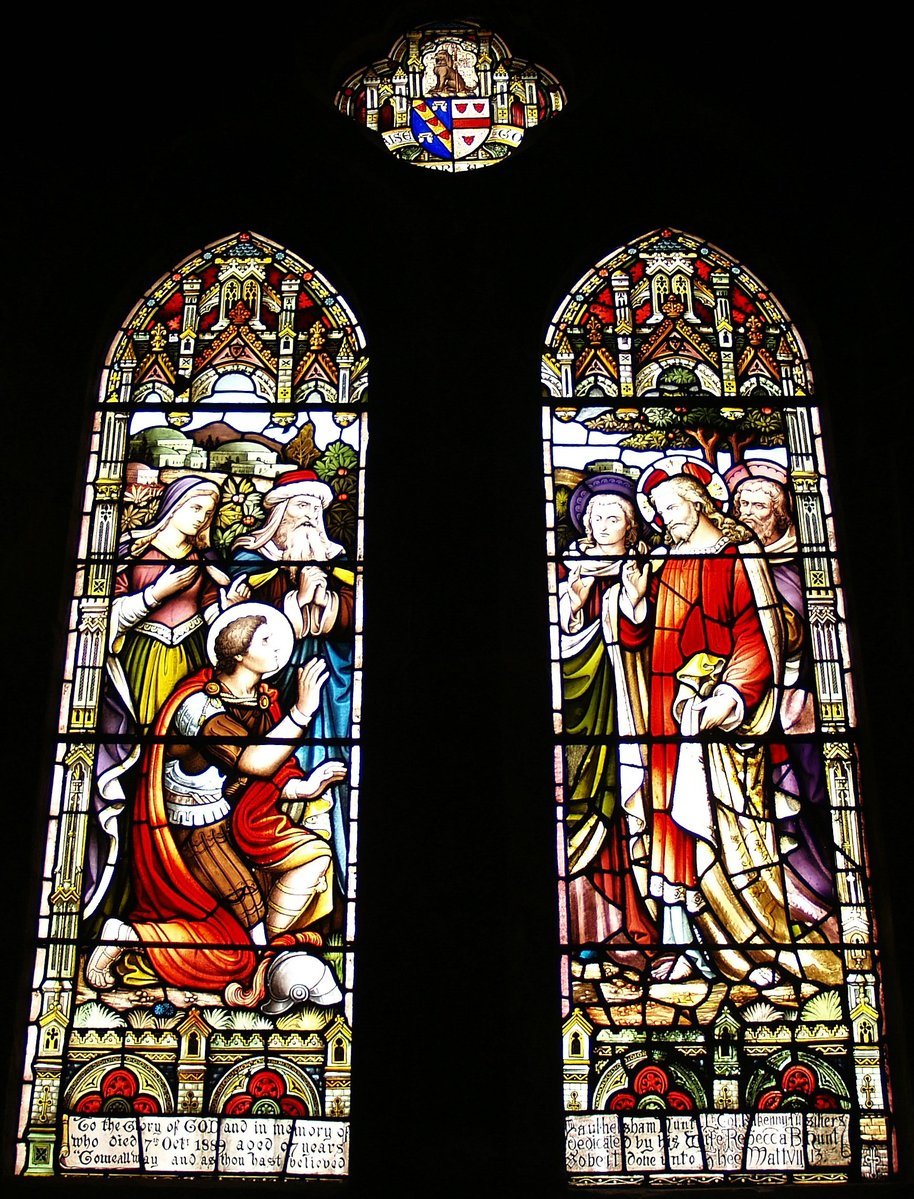 two stained glass windows with people in the background