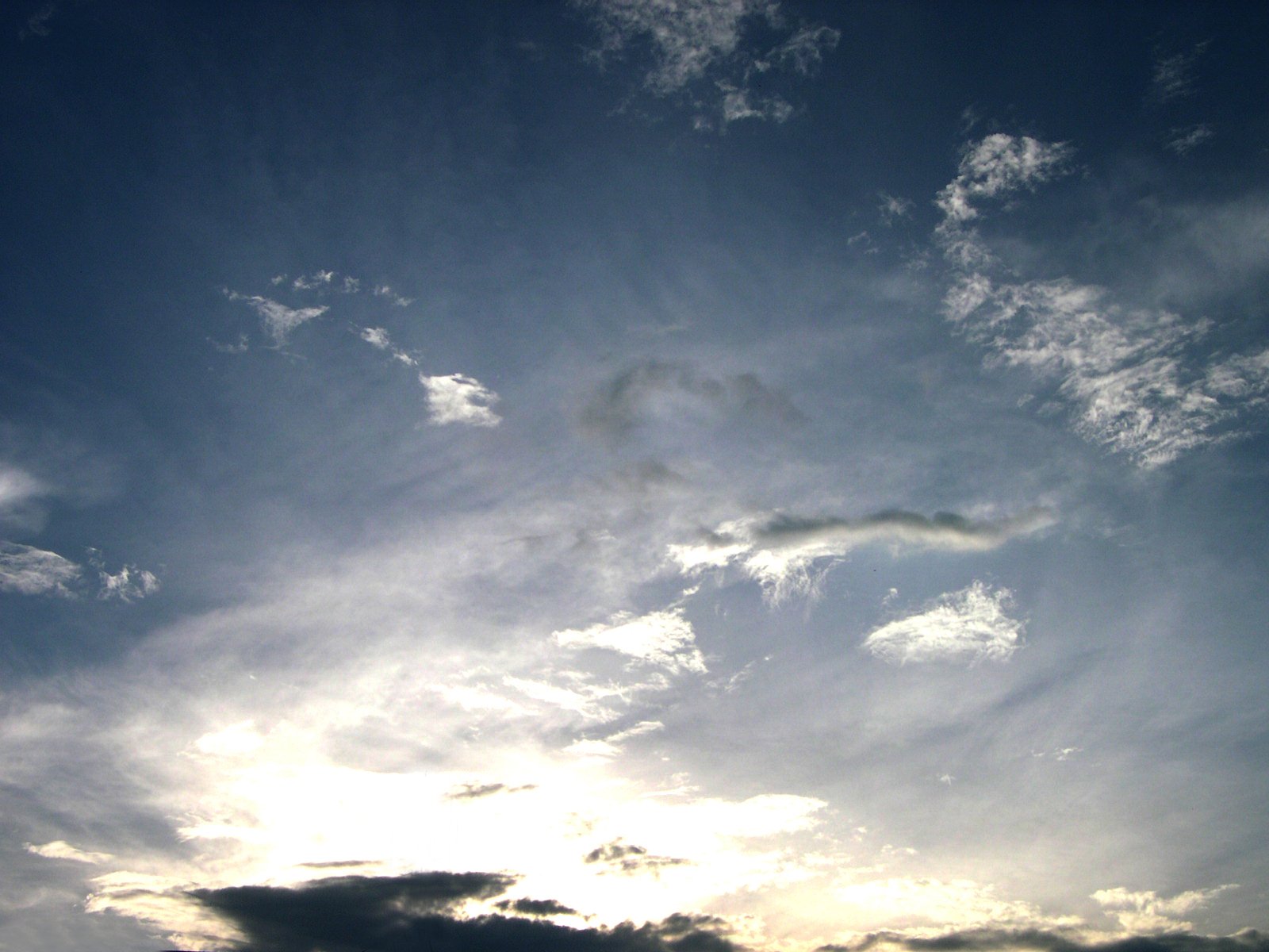 an airplane in the sky with a lot of clouds