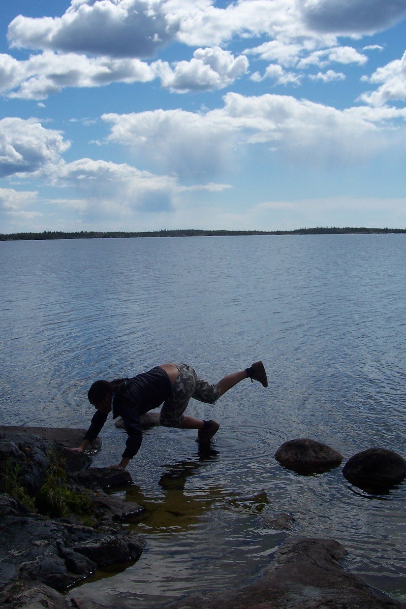 an older man playing with a fish in the water