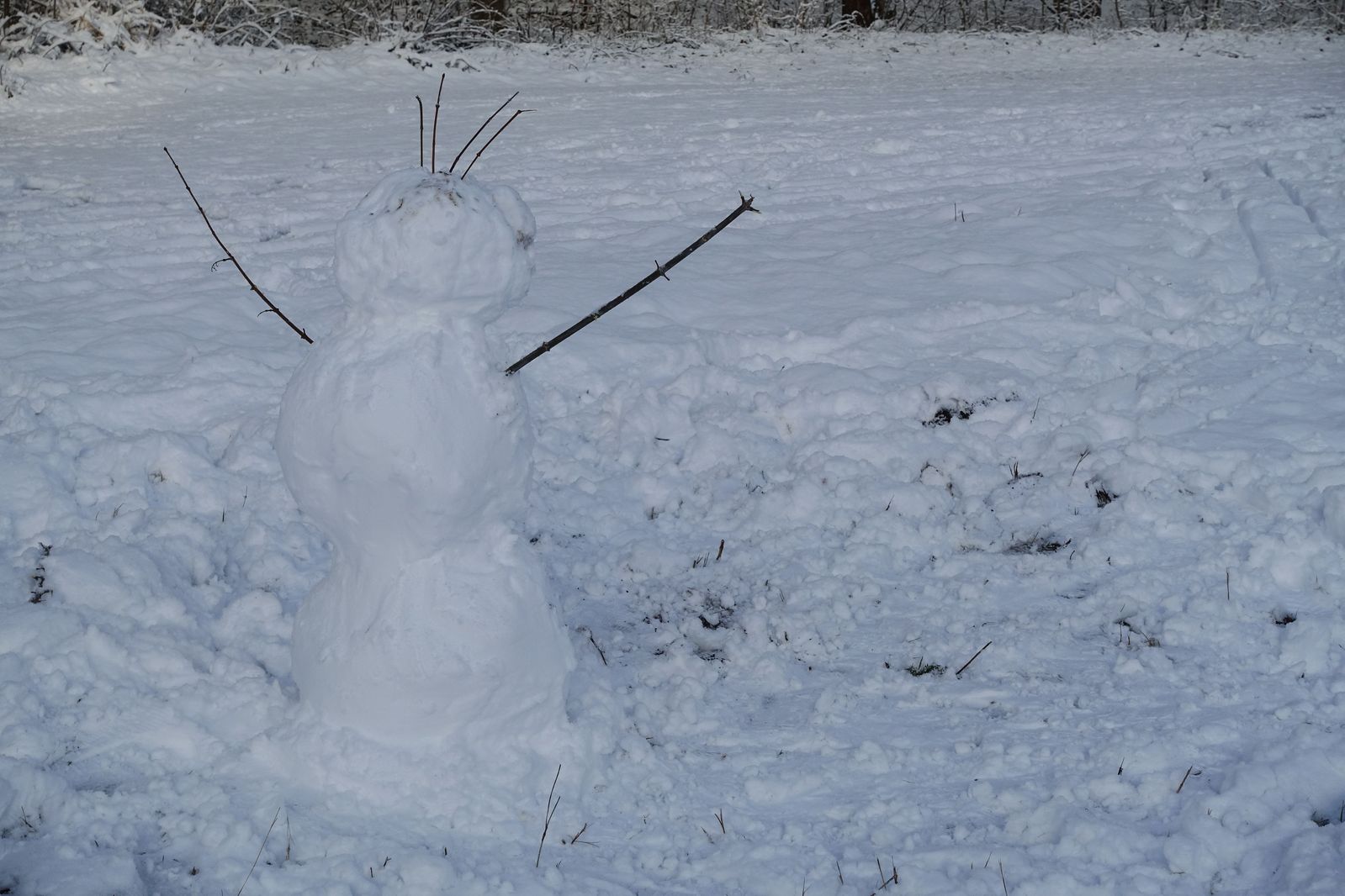 a very tall snowman made out of skis on the snow