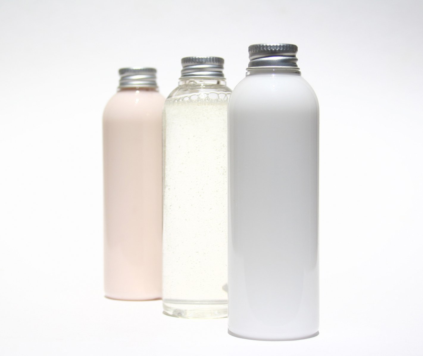 three colored glass bottles lined up side by side