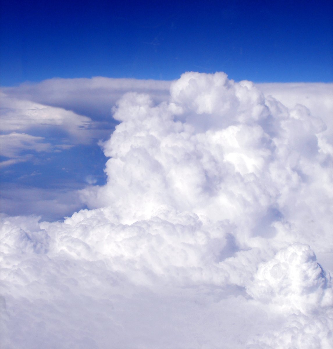 an airplane flying through the clouds as it passes