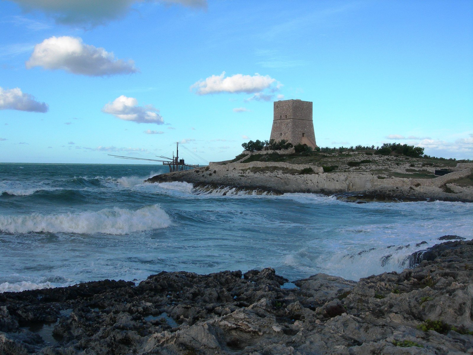 a tower in the ocean and waves around it