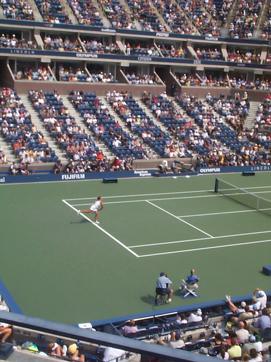 a tennis match in the middle of a crowded stadium