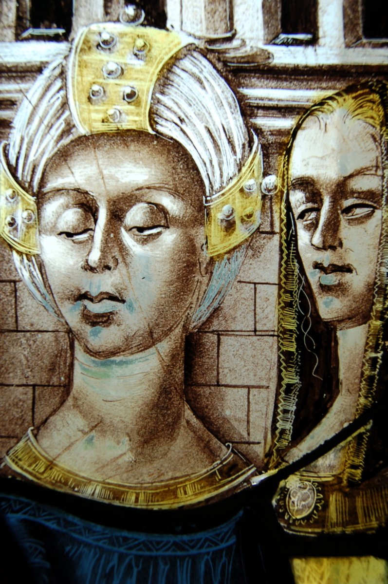 a drawing on a plate of two women with golden crowns