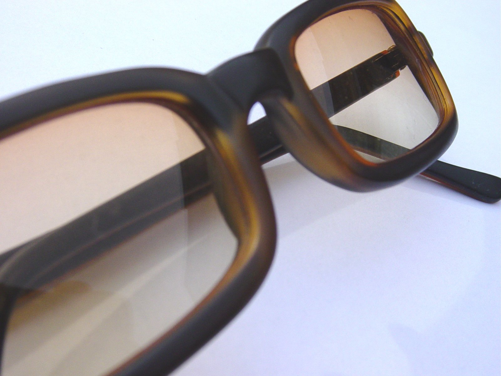 a pair of brown colored glasses with rectangular frames