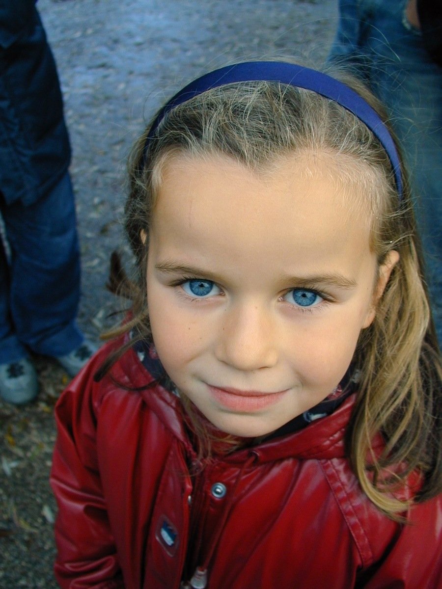 a  in a red jacket posing for a picture