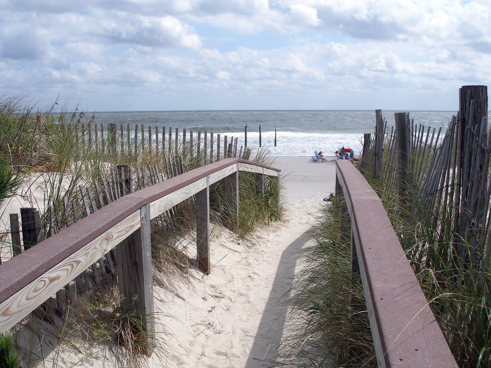 an elevated path leads into the beach