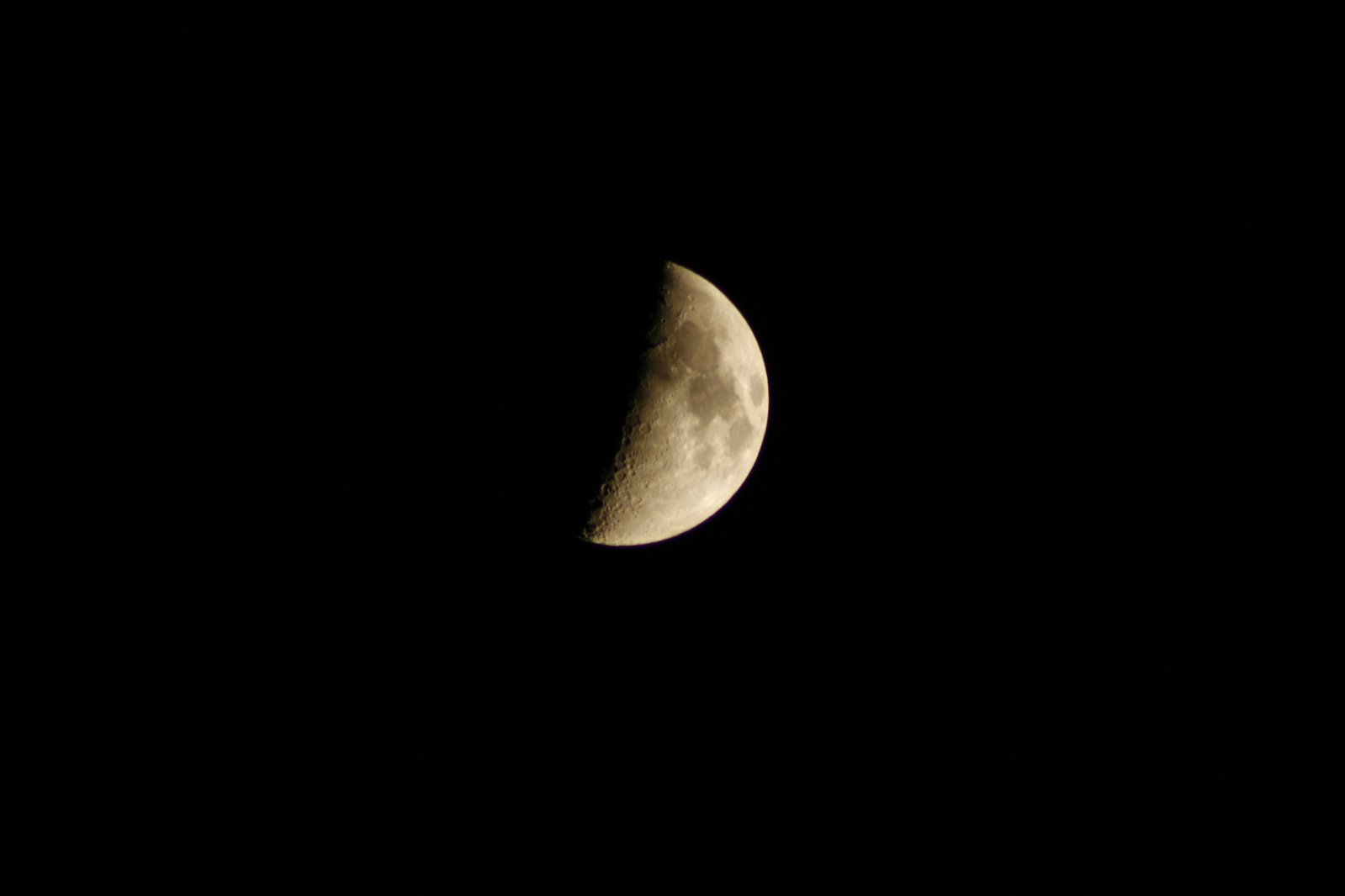 the side of a moon with its half moon in the background