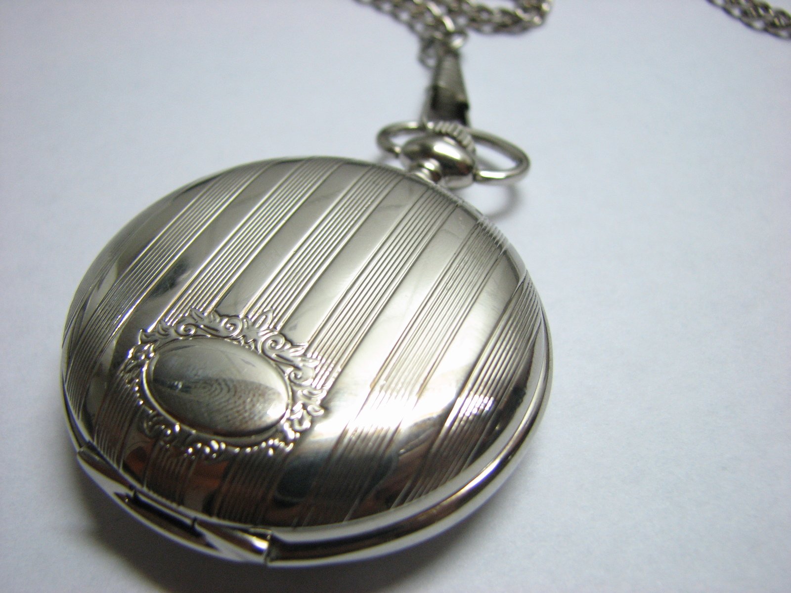 an antique pocket watch hanging on a chain