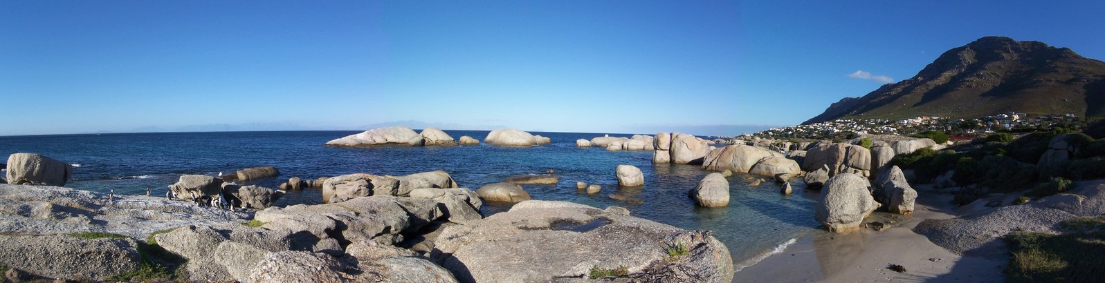 a very beautiful beach with some rocks by the water