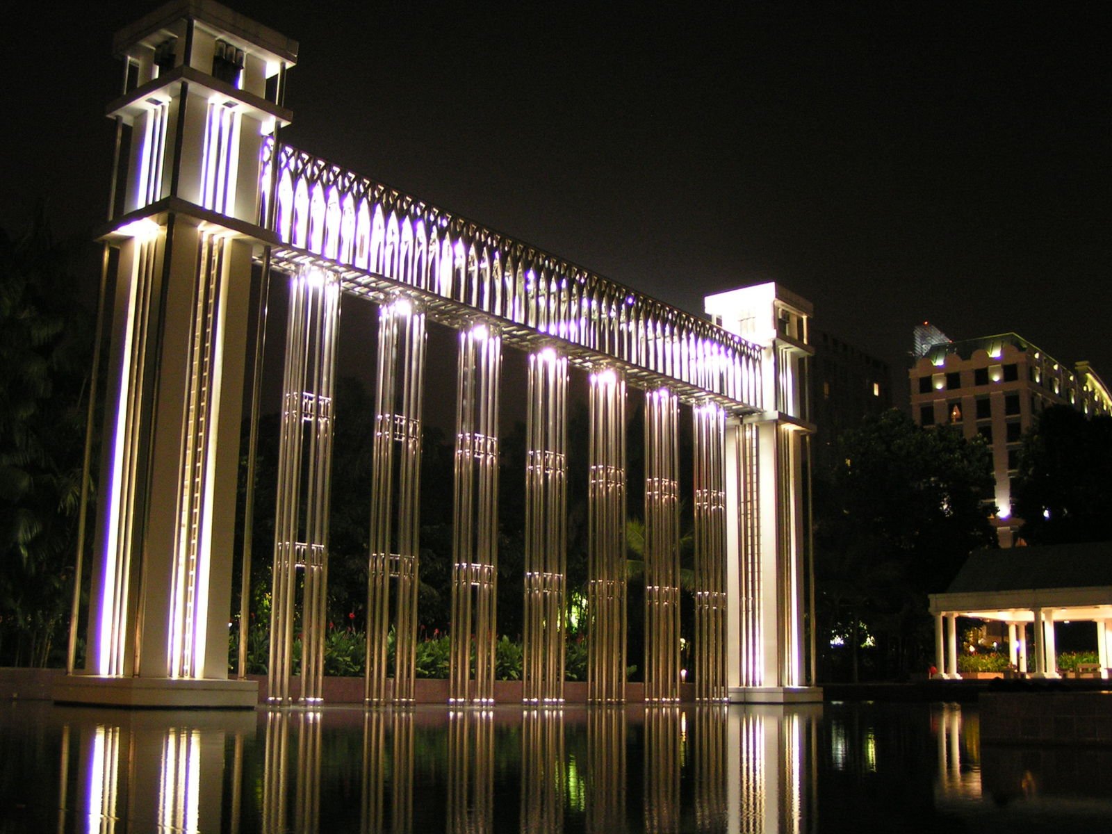 the lighted sculpture in front of the large building is illuminated